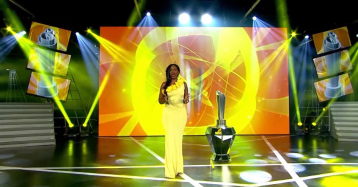 Host on the stage of the Premier Soccer League Awards, with video walls displaying background visuals
